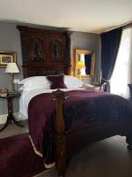 a bedroom with a large bed with a wooden headboard at The Rookery in London