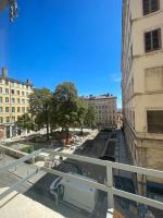 a view of a city street from a balcony at Le soyeux in Lyon