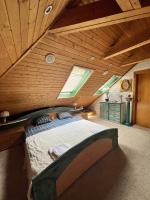 a bedroom with a large bed in a wooden ceiling at B&amp;B Chardas in Bük