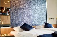 A bed or beds in a room at ELLBy Apartman - PENTHOUSE - hostAID
