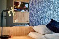A bed or beds in a room at ELLBy Apartman - PENTHOUSE - hostAID