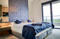 A bed or beds in a room at ELLBy Apartman - PENTHOUSE - hostAID