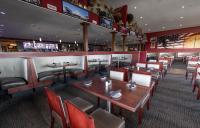 a restaurant with tables and chairs and a bar at The Resort at Lake of the Ozarks in Lake Ozark