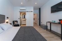A bed or beds in a room at La Posada del Teatro H Boutique Parking Gratis