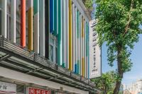 a building with colorful banners on the side of it at CU Hotel Taipei in Taipei