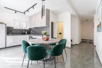 a kitchen with a table and green chairs at Luxury D Apartments in Bibinje