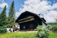 a wooden house with a balcony on the side of it at Beim Oswald in Bad Kleinkirchheim