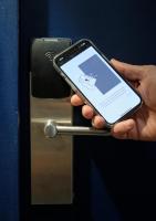 a person holding a cell phone in front of a door at Maison Juste in Marseille