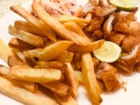 a plate of french fries with a slice of lime at Pole Pole Beach House in Watamu