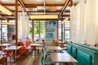 a restaurant with tables and chairs and windows at Apartamentos LIVVO Morromar in Puerto del Carmen