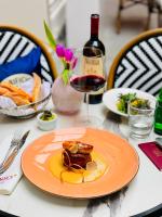 Un plato de comida en una mesa con una copa de vino. en Hotel van Bebber, en Xanten