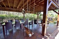 a wooden deck with a long table and chairs at Sitou Peach Villa B&amp;B in Lugu Lake