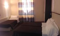 Postel nebo postele na pokoji v ubytování Hotel Tritone