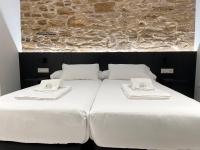 A bed or beds in a room at Ultreia Seven Rooms by Adeloló