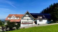 a large white house with a red roof at Hirschen Wald - Gasthaus &amp; Bäckerei in Wald