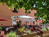 a restaurant with tables and chairs and an umbrella at Das Geringer in Schladming