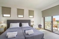 A bed or beds in a room at Villa Nikos Olivestone by Villa Plus