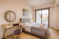 A bed or beds in a room at Villa Nikos Olivestone by Villa Plus
