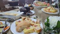 a table with plates of food and bowls of desserts at Hotel Amazon Palace in Itaituba