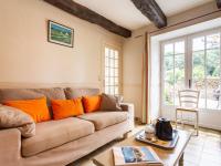 a living room with a couch and a table at Holiday Home La Vallée by Interhome in Cancale