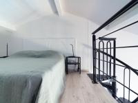 a white bedroom with a bed and a chair at Apartment Les Jardins d&#39;Amaryllis-8 in Cavalaire-sur-Mer