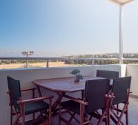 a table and chairs on a balcony with a view at Apartment Santa Marina 4 in Asgourou