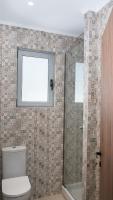 a bathroom with a shower and a toilet and a window at Apartment Santa Marina 4 in Asgourou