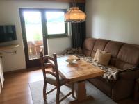 a living room with a table and a couch at Appartement Oberlacken in Sankt Johann in Tirol