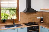 a kitchen with a stove and a sink and a window at Villa Lucia in Skradin