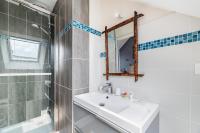 a bathroom with a sink and a shower and a mirror at La Maison des Fées in Pleudihen-sur-Rance