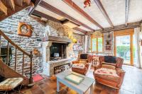 a living room with a stone wall at La Maison des Fées in Pleudihen-sur-Rance