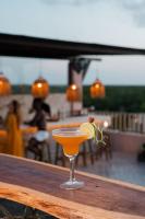 een cocktail op een houten tafel met een drankje bij Xkeban Tulum Adults Only in Tulum