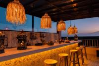 een bar met barkrukken en kroonluchters bij Xkeban Tulum Adults Only in Tulum