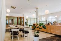 um restaurante com mesas e cadeiras de madeira e uma cafeteria em Hotel Korkyra em Vela Luka