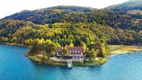 a house on an island in the middle of a lake at Abant Kosk Oteli in Abant