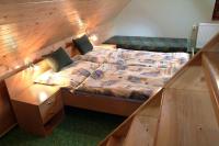 A bed or beds in a room at Chalupa LUKA Terchová