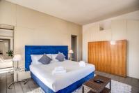 A bed or beds in a room at Magia at Colosseum