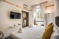A bed or beds in a room at Magia at Colosseum