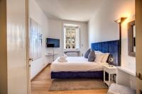 A bed or beds in a room at Magia at Colosseum