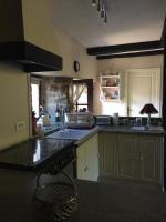 a kitchen with a sink and a counter top at Gîte Maison Maitri in Forgès