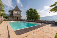 a swimming pool in front of a house with a tower at Les Tours Carrées in La Motte-Servolex