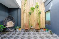 a patio with chairs and a swing and plants at La Buena Vida Inn in San Juan