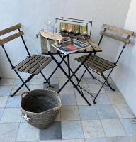 a table and two chairs and a table with a basket at Villa Pigouille in Sainte-Marie-de-Ré