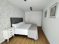 A bed or beds in a room at Second Home Arzúa apartamentos
