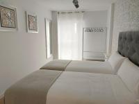 A bed or beds in a room at Second Home Arzúa apartamentos