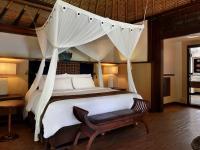 a bedroom with a large bed with a canopy at Novotel Lombok Resort & Villas in Kuta Lombok