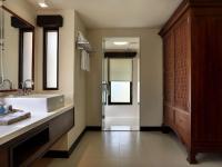 a bathroom with a sink and a shower and a mirror at Novotel Lombok Resort & Villas in Kuta Lombok