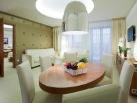 a living room with a table with fruit on it at Hotel Vitality in Vendryně