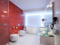 a bathroom with two sinks and a bath tub at Hotel Vitality in Vendryně