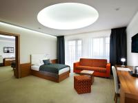 a hotel room with a bed and a couch at Hotel Vitality in Vendryně